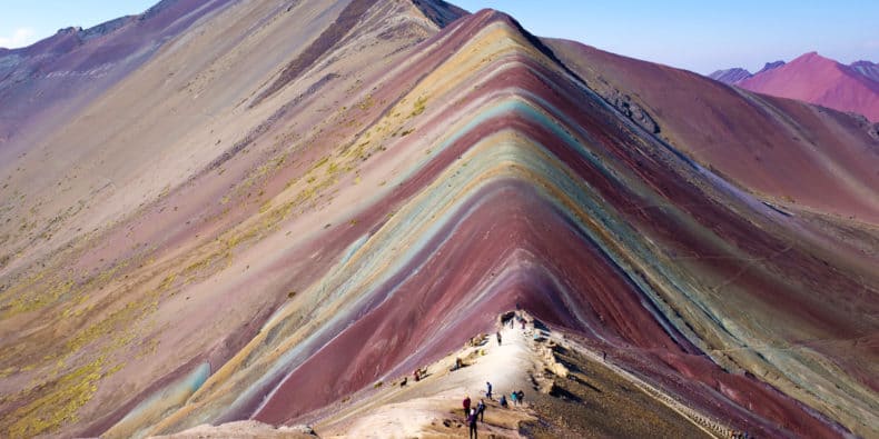 Backpackers at the top of Rainbow Mountain in Cusco, Peru